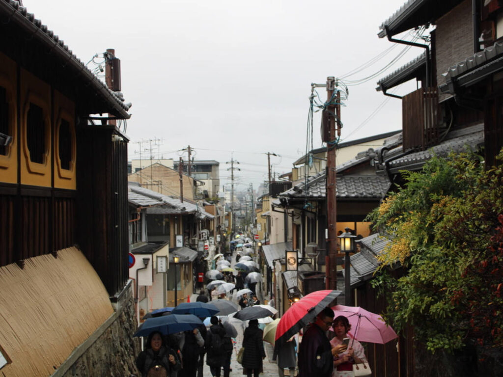 Japanese locals and tourists walking with an umbrella on a gloomy day in Kyoto