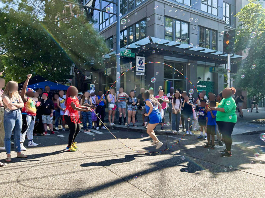 People watching the girls playing double dutch jump rope in Capitol Hill