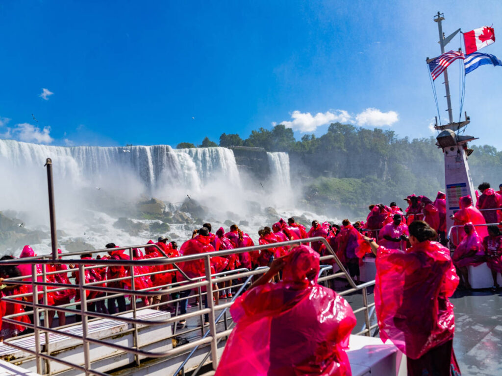People on a tour in Niagara Falls wearing a raincoat