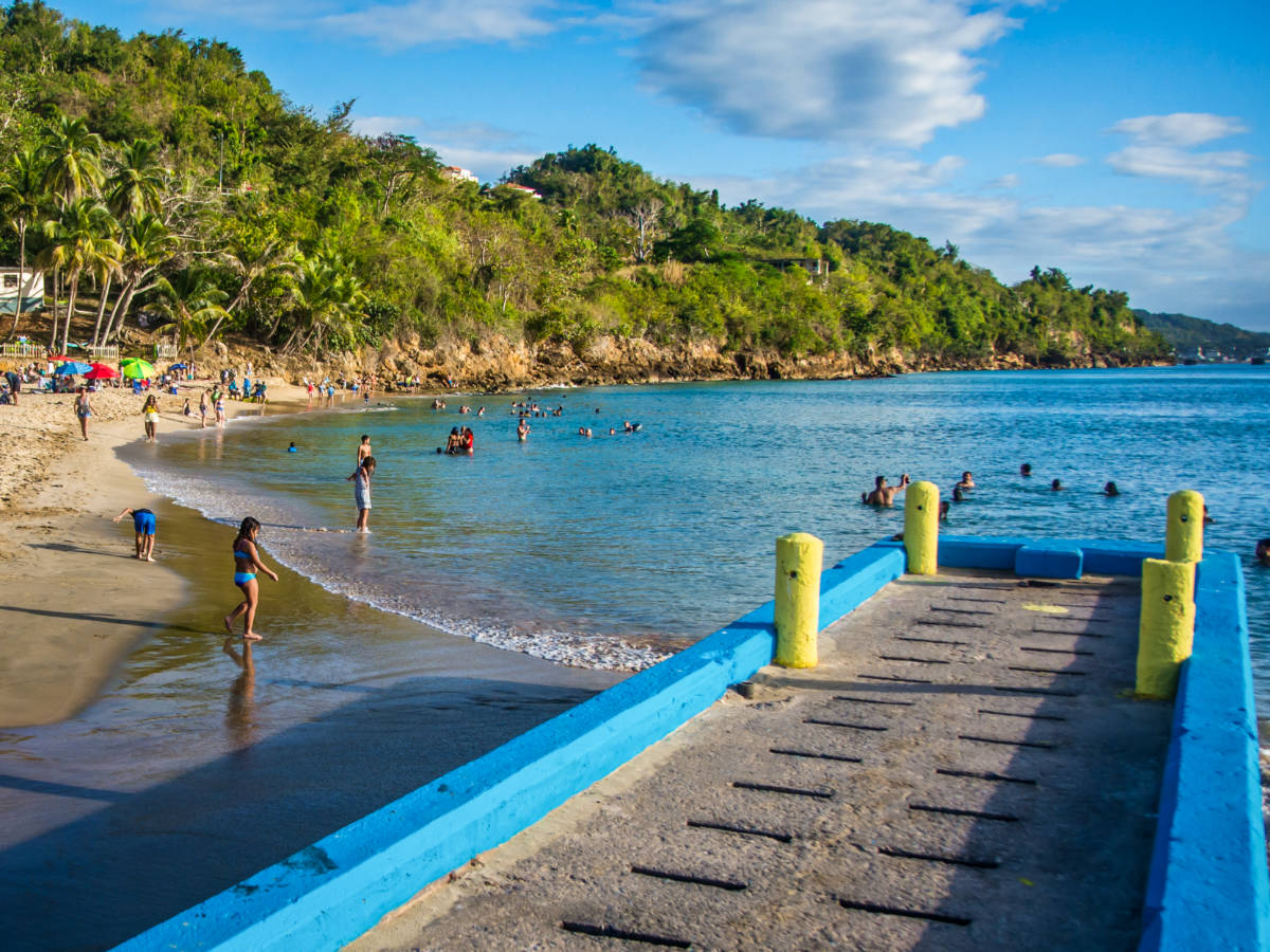 A boardwalk and the people enjoying at the beach in Aguadilla