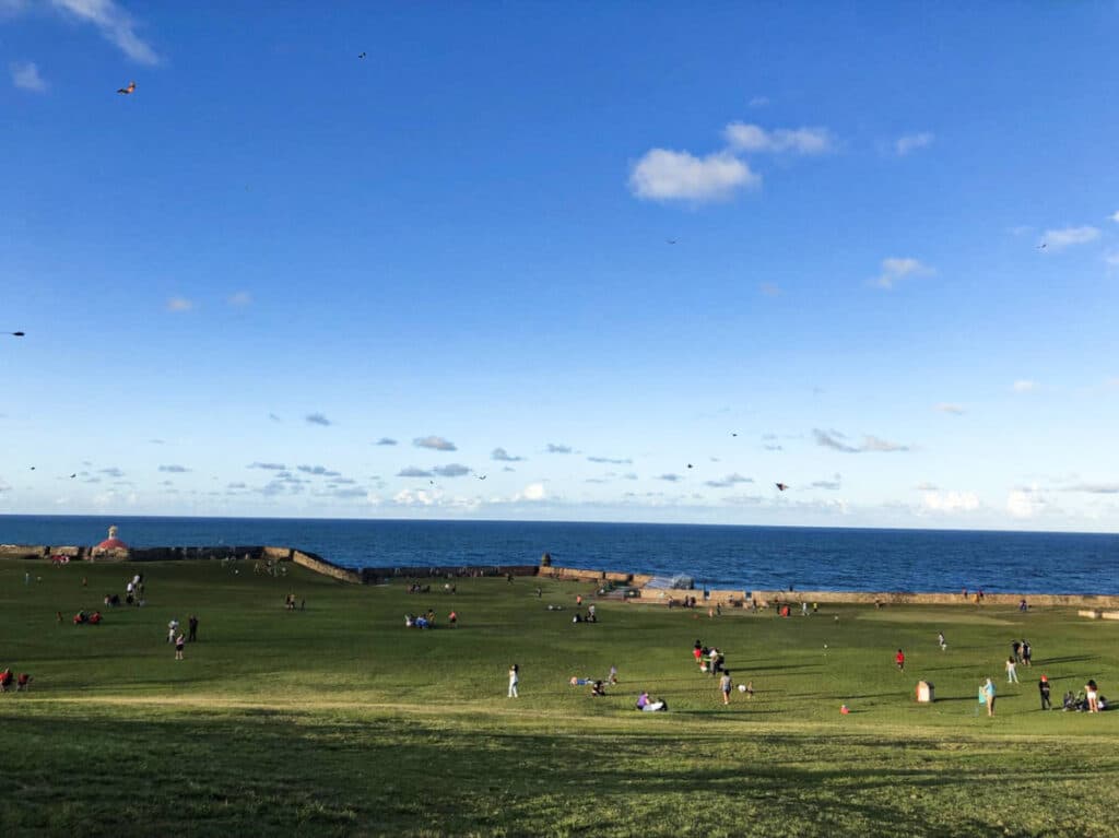 View of the people flying kites and relaxing outside Castillo San Felipe del Morro