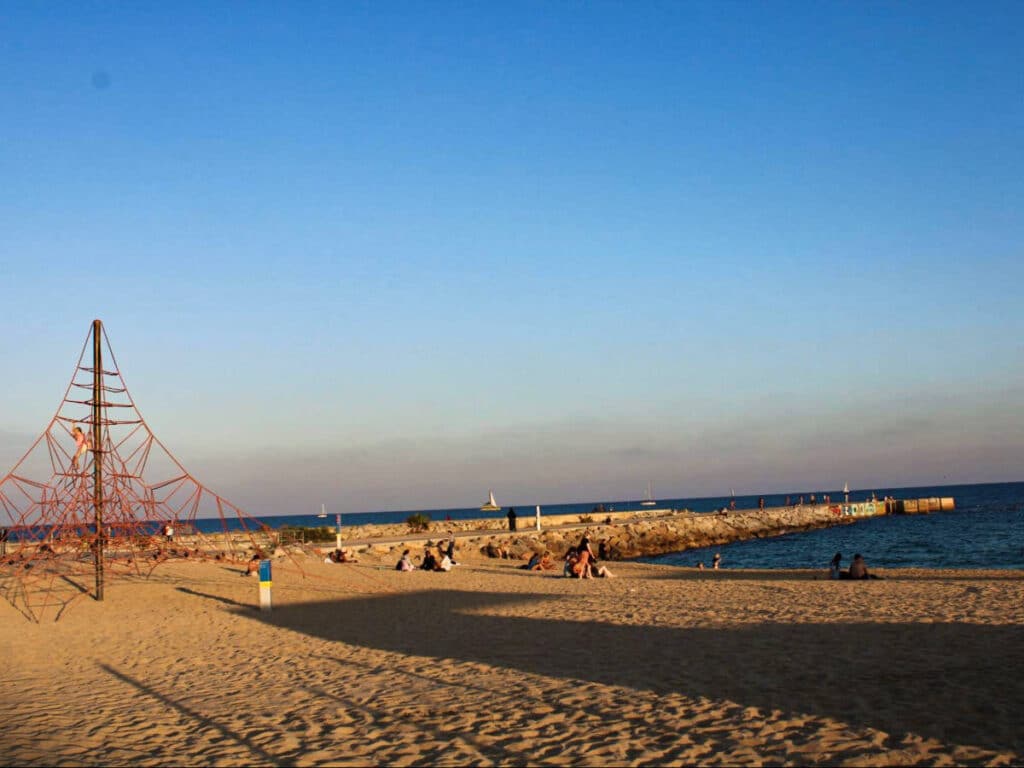View of the people chilling at the Costa Brava at sunset