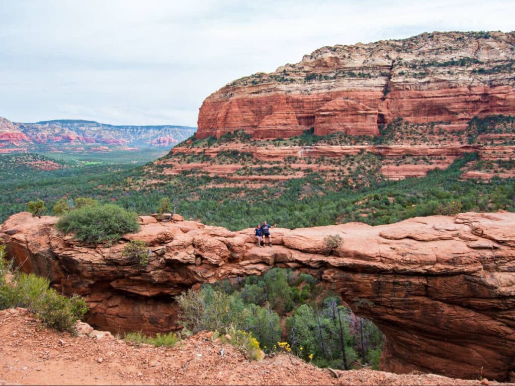 A old man and woman sitting at the Devil’s Bridge with the magnificent rock formations in the background