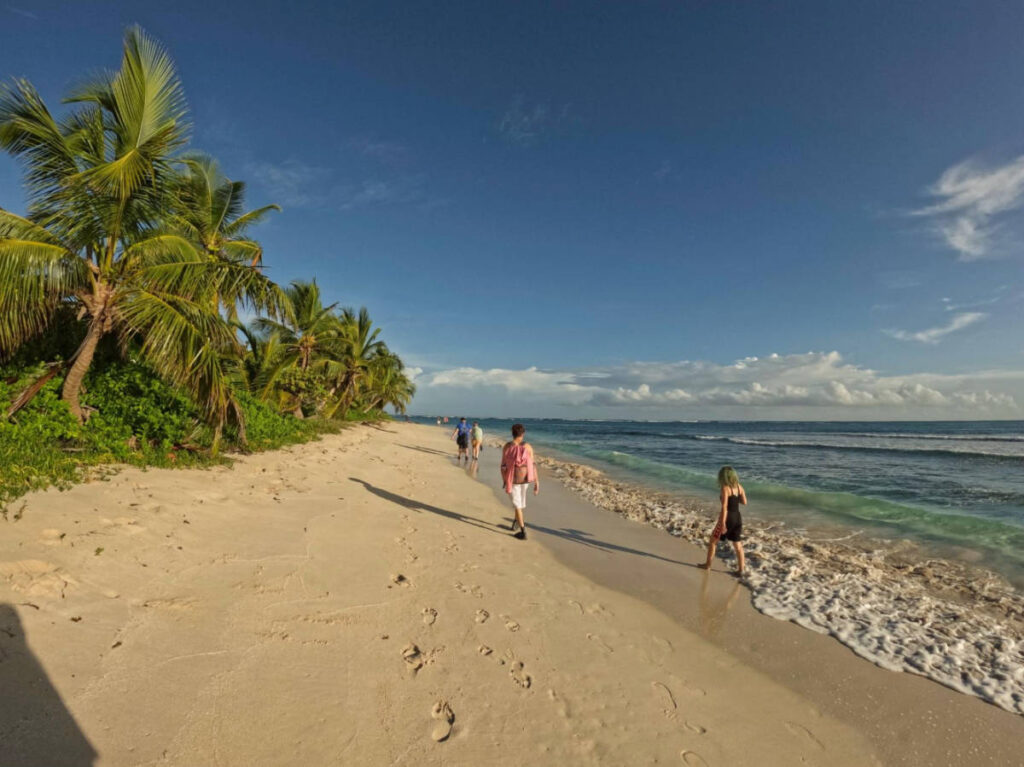 The author's family and friends walking on the shoreline of Flamenco Beach