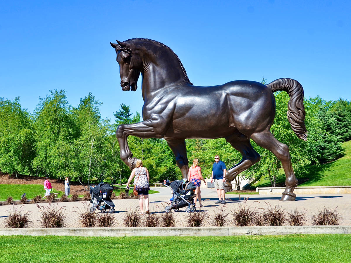View of the people admiring the huge black horse sculpture at Frederick Meijer Gardens & Sculpture Park