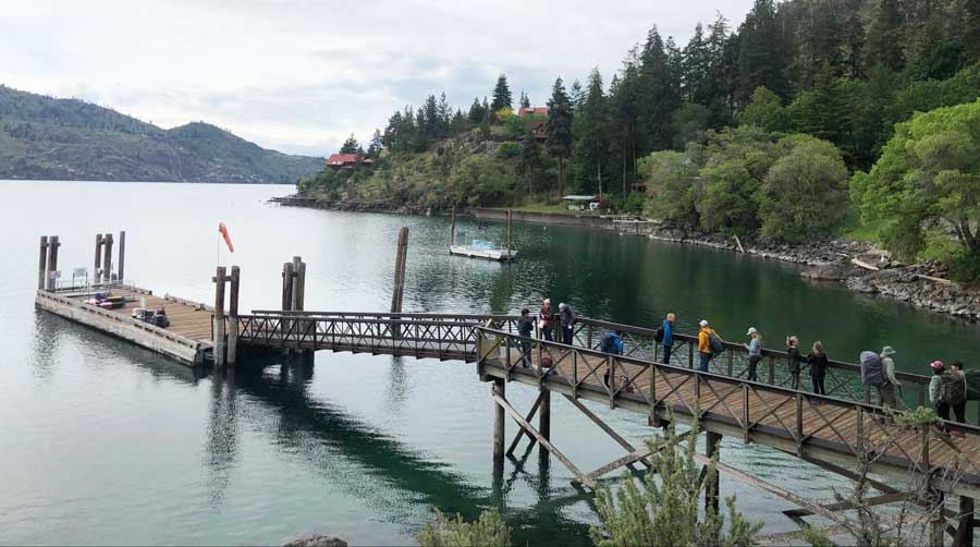 People enjoying on the boardwalk over the Lake Chelan