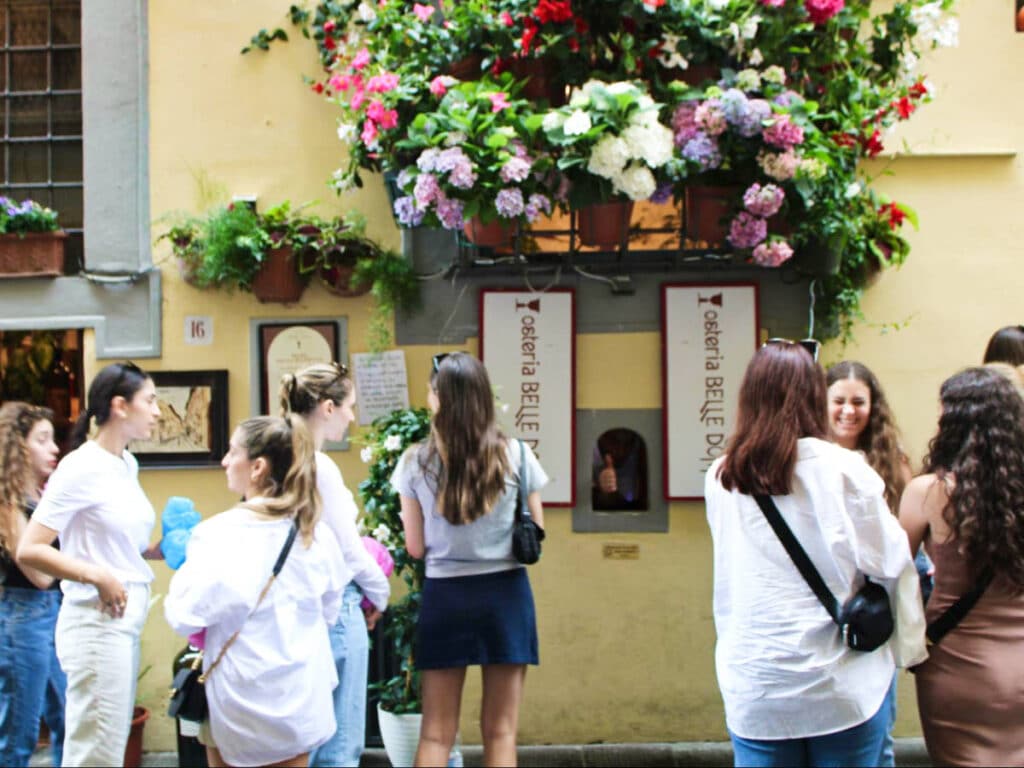 View of the people waiting in line outside the Osteria Belle Donne Wine Window