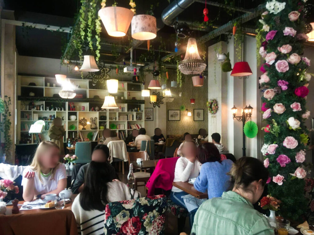 View of the flowery interior and the people enjoying inside the T’Cup restaurant