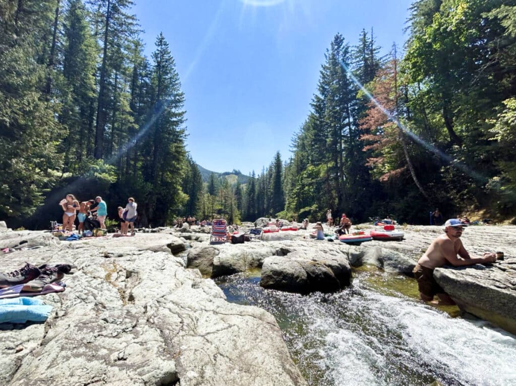 View of the people chilling on the rock area upstream at Naked Falls