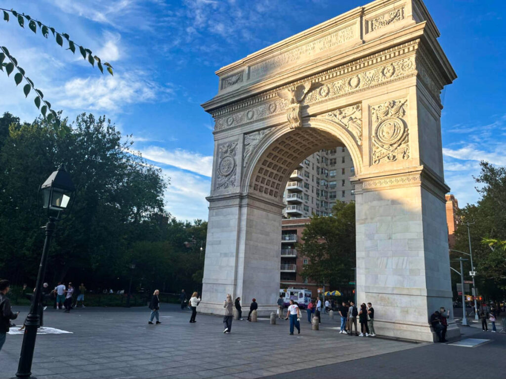 The people wandering around Washington Square Arch