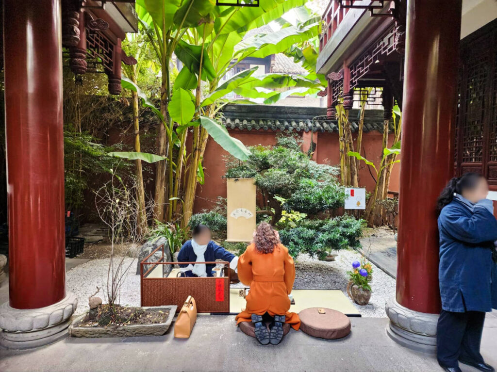A woman learning traditional tea culture at Wenshu Monastery
