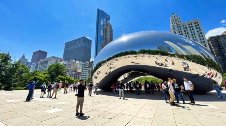 View of the people taking photos around the Cloud Gate on a sunny day