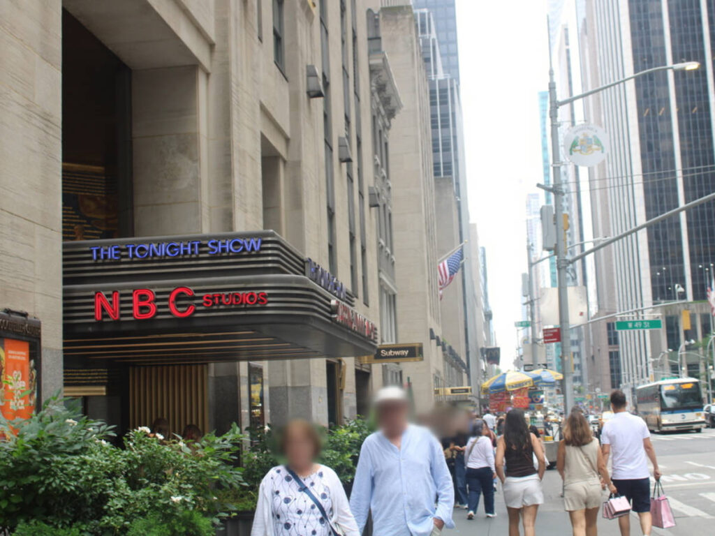 People walking outside the entrance for The Tonight Show set