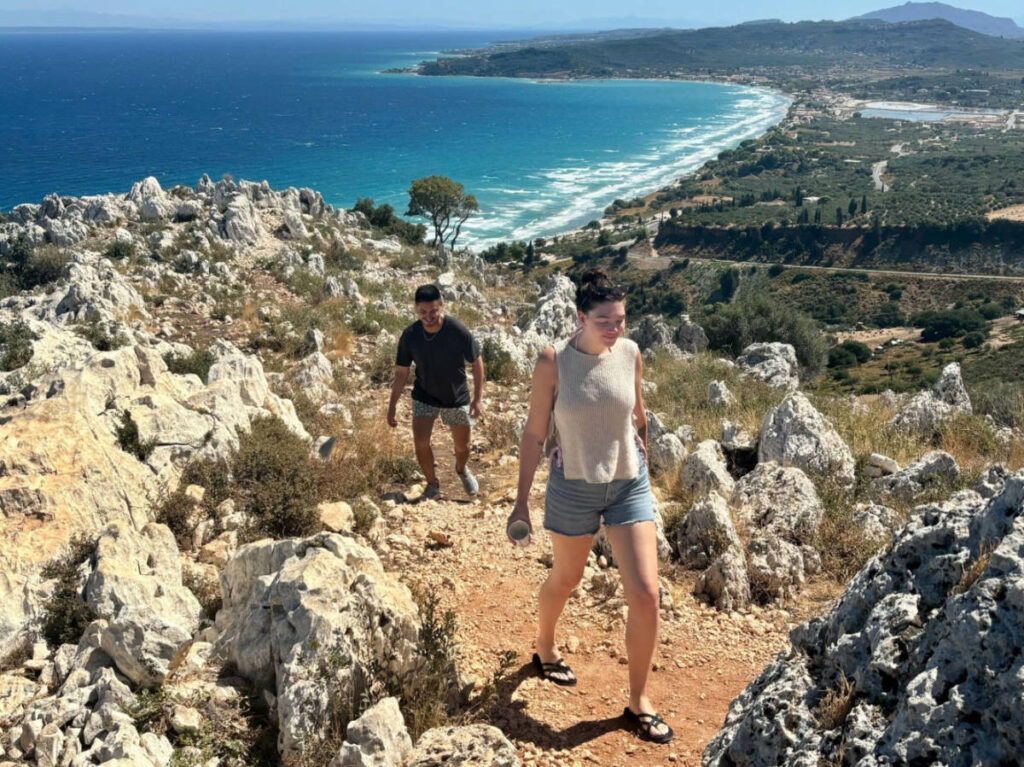 people walking on the rocky and steep hills in Greece