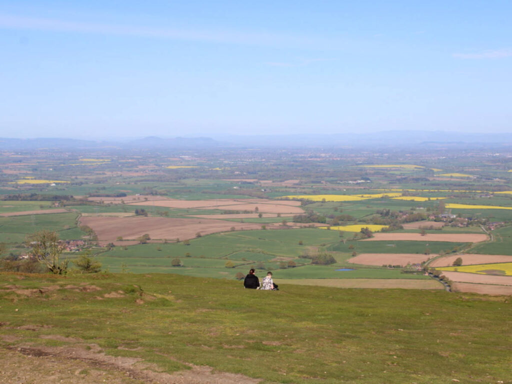 People relaxing at the top of a hill