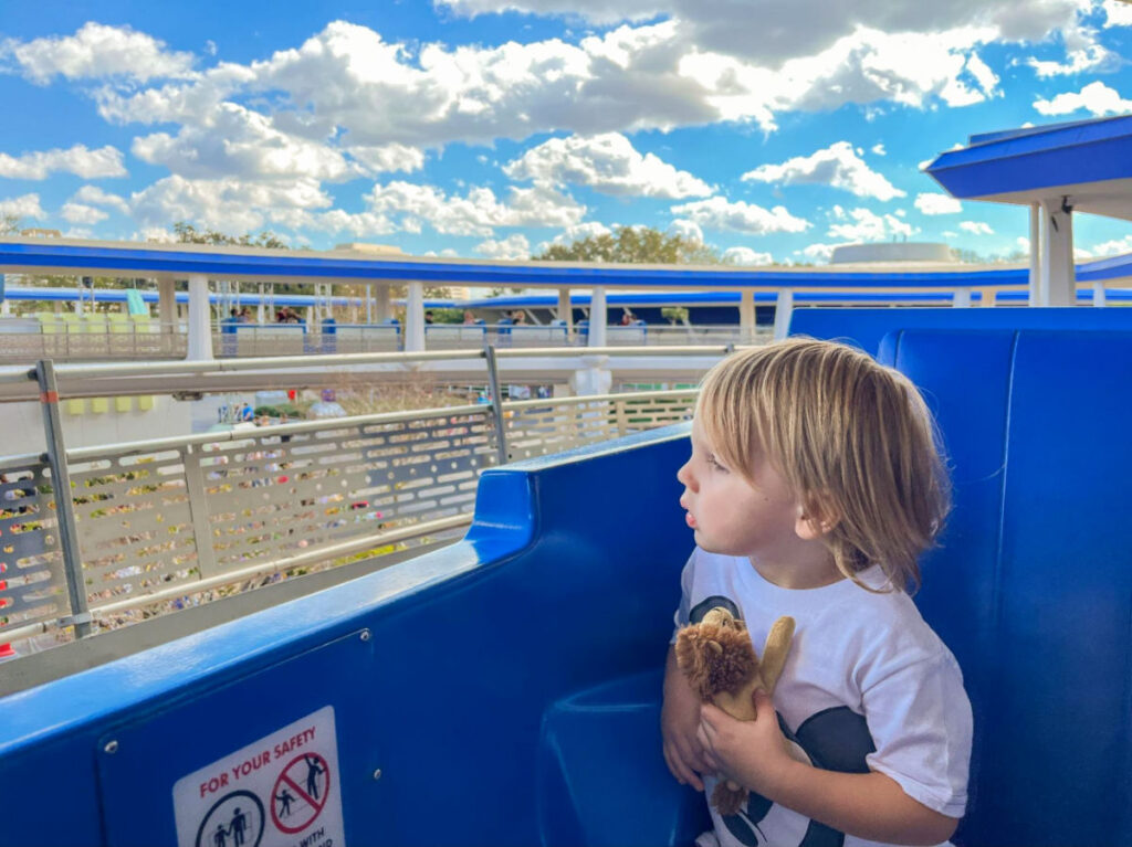 A young boy enjoying a ride at PeopleMover in Magic Kingdom