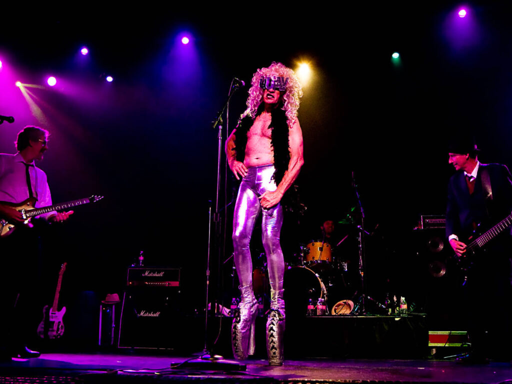A performer with the band on the stage of The Triple Door