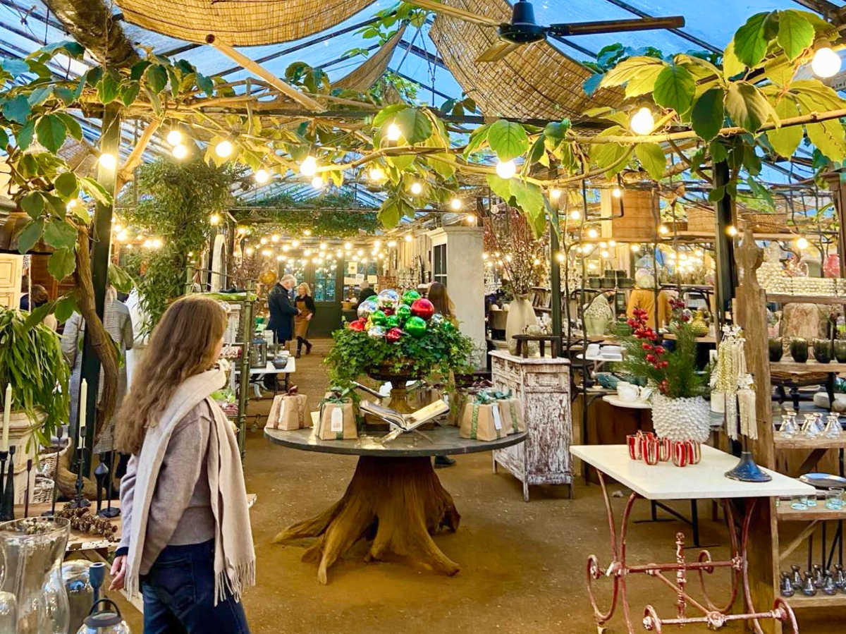 People wandering around the Petersham Nurseries Shop at night