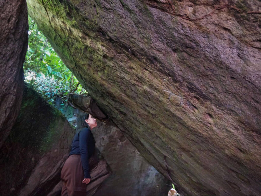 The author Vanessa Ramos looking at the petroglyphs in Las Piedras