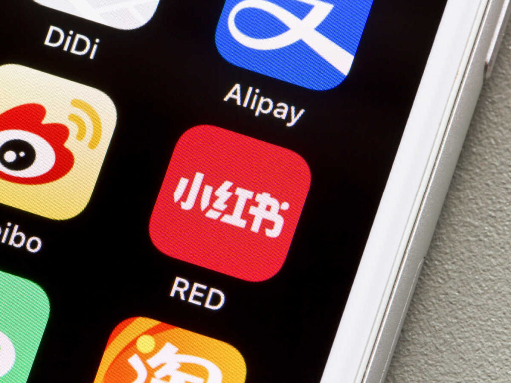 A phone with some popular apps in China, including Alipay, DiDi, Weibo, and Little Red Book