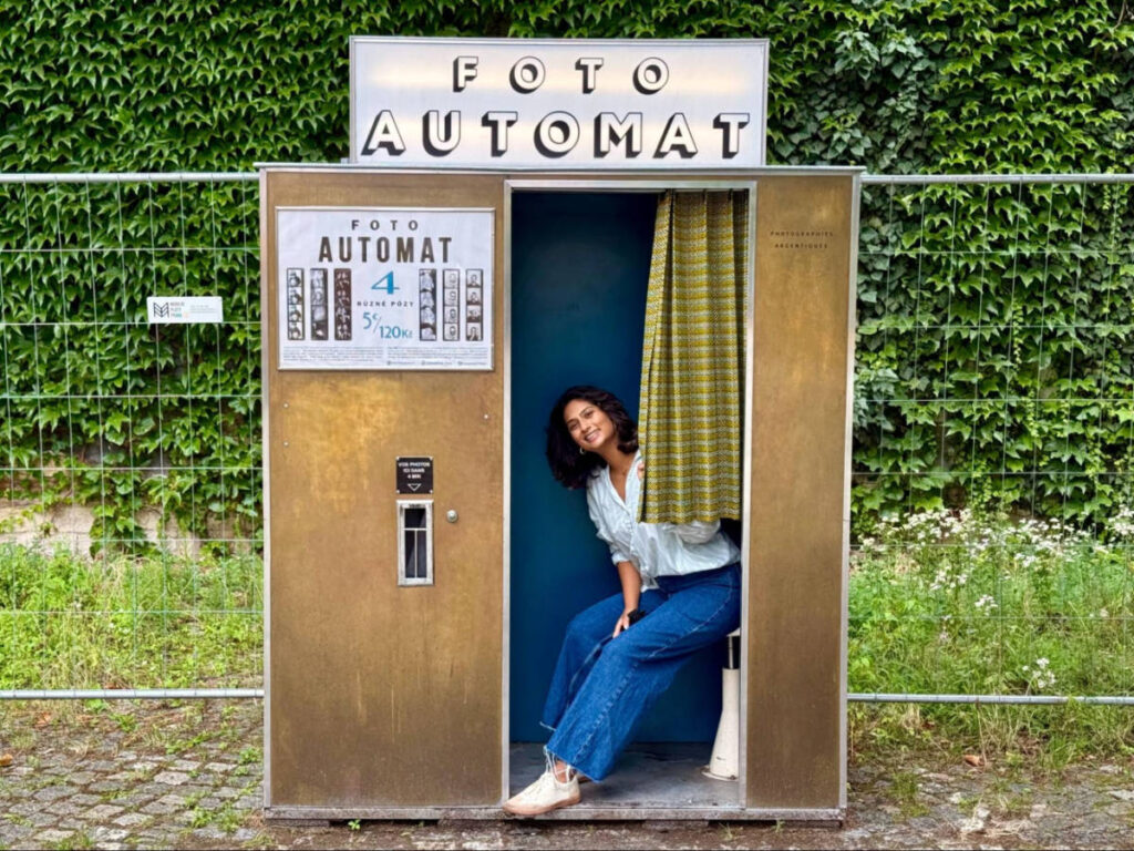 Author Meera trying out the vintage photobooth in Kasárna Karlín