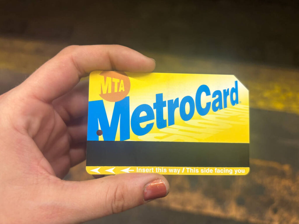 A hand holding the physical MetroCard