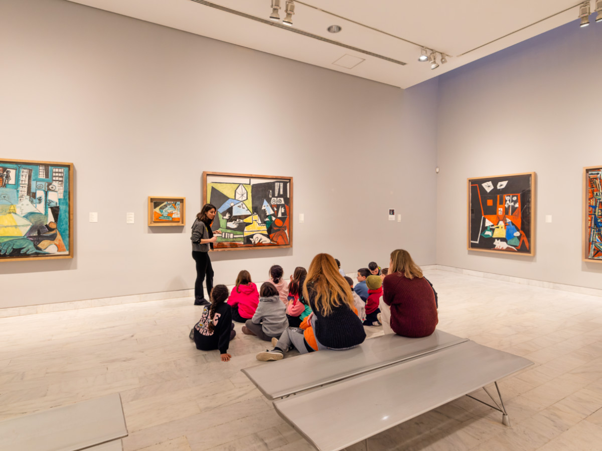 A teacher teaches students about art inside the Picasso Museum