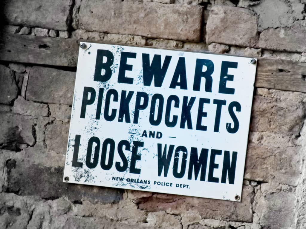Signage of "Beware Pickpockets and Loose Women Signage" on the wall in New Orleans