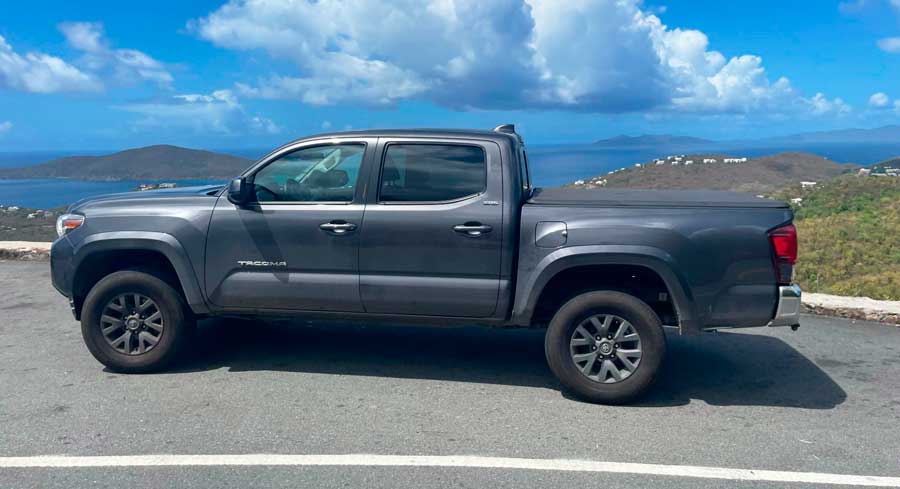A pickup truck with a view from its background on USVI