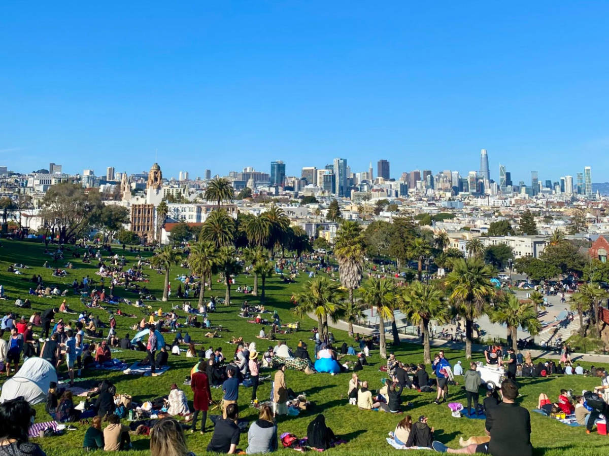 Group of people enjoying a picnic at Mission Dolores Park