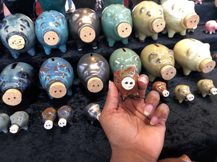 The author holding a small piggy bank from Pike Place Market