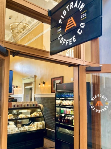 View of the signage and interior from the entrance of Pigtrain Coffee Co.