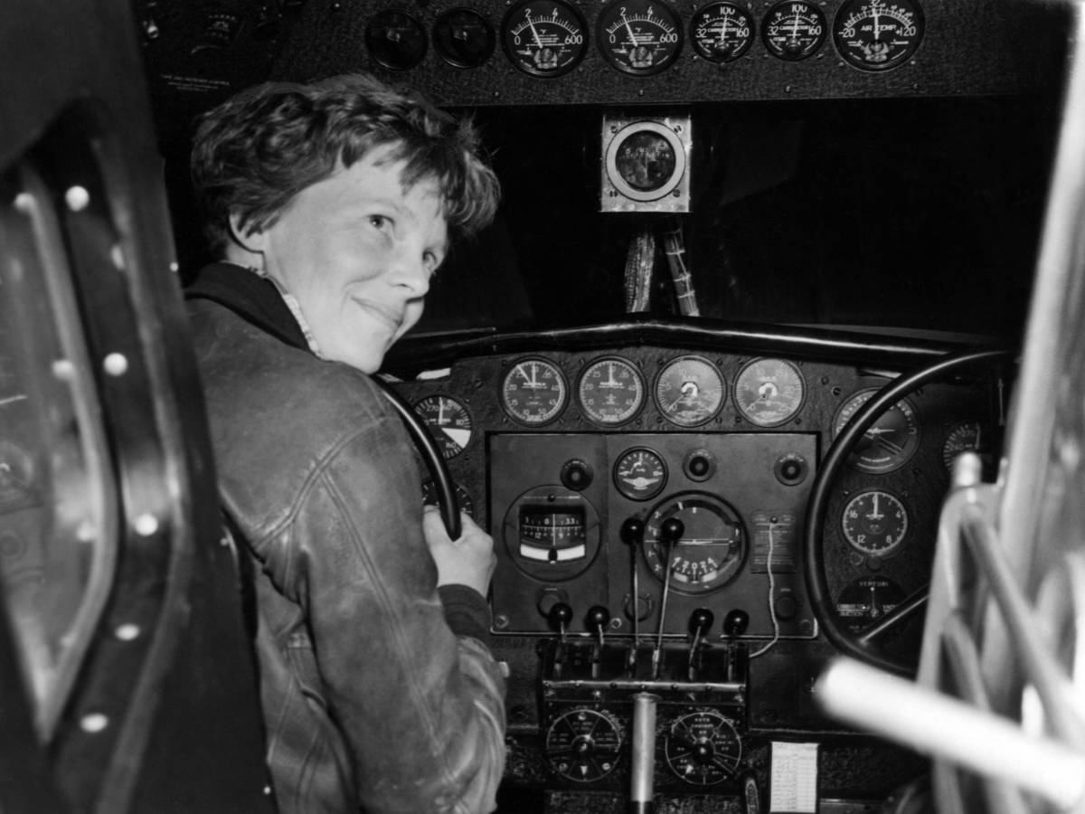 A black and white photo of a pilot named, Amelia Earhart