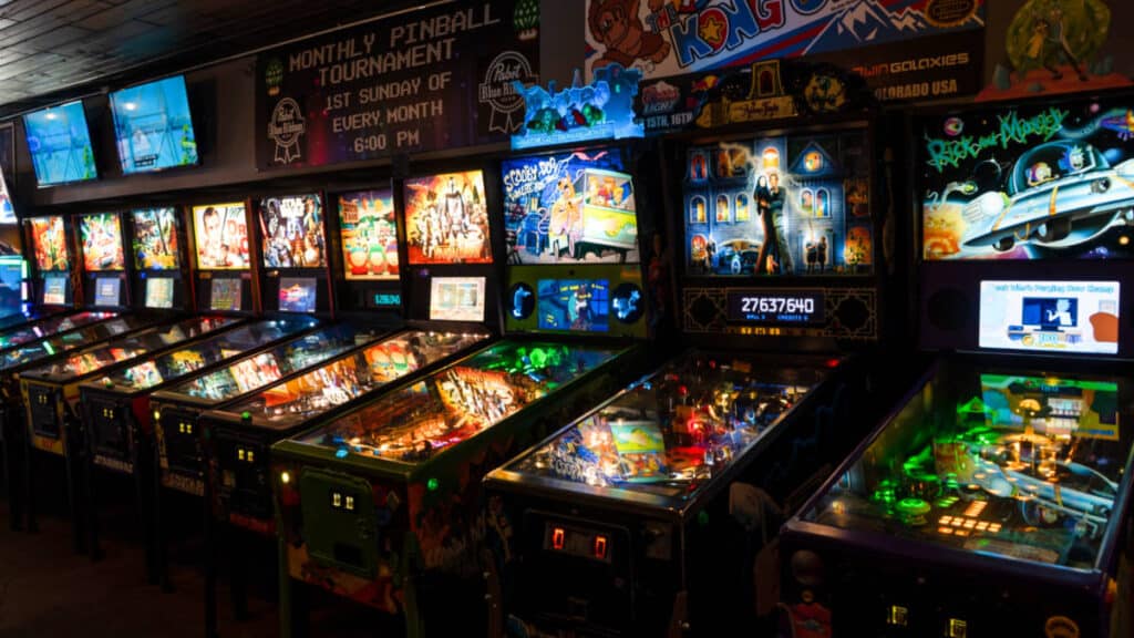 View of the illuminated pinball machines at 1Up Arcade Bar