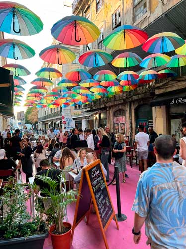 View of people enjoying their day in Colorful Umbrellas in Pink Street