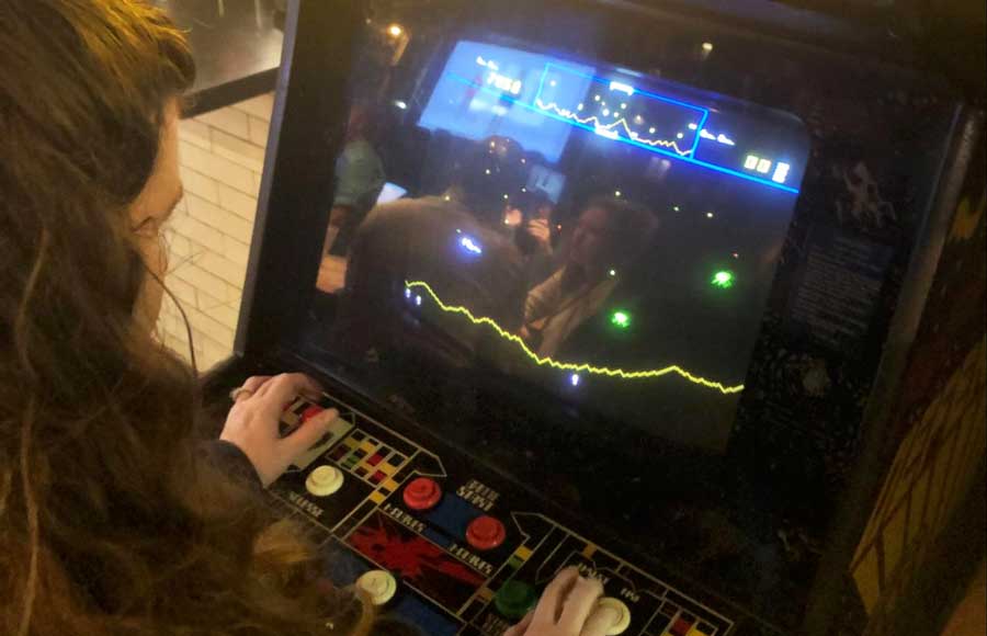 The author playing a retro arcade game in Pins Mechanical
