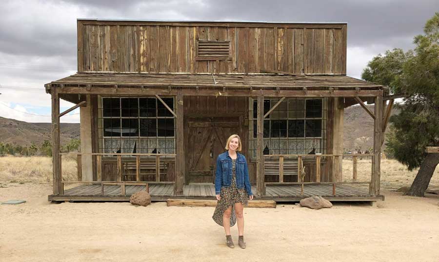 The author in front of an old west style building in Pioneertown