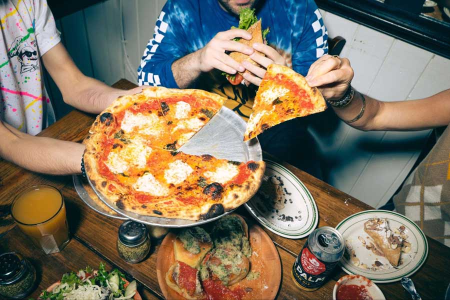 People enjoying their pizza from Pizza Bruno