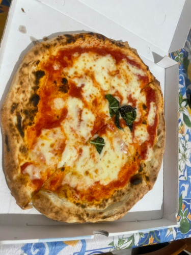A pizza from L’Antica Pizzeria da Michele placed on a table