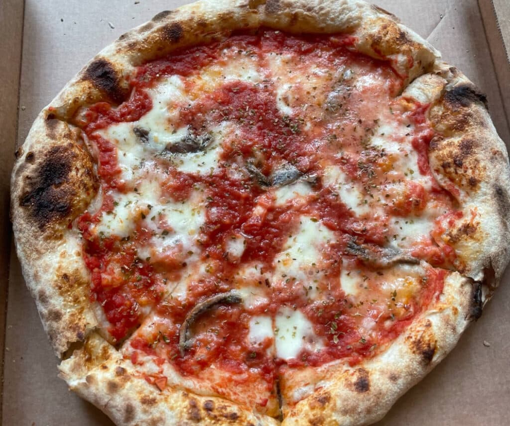 A whole pizza on a box