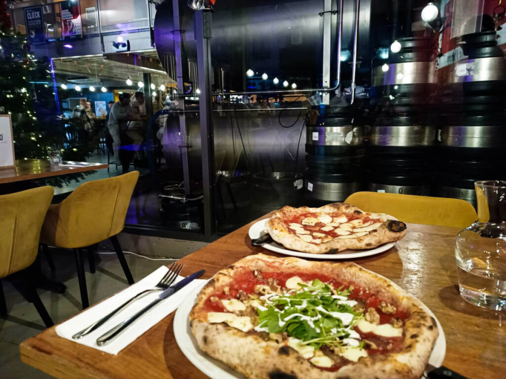 Two variety of pizzas on the table at Zerodegrees Microbrewery Restaurant