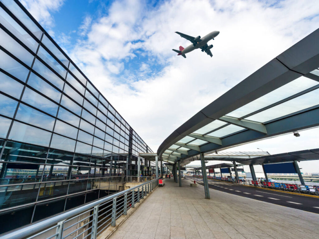 A plane flying over at an airport in Shanghai, China