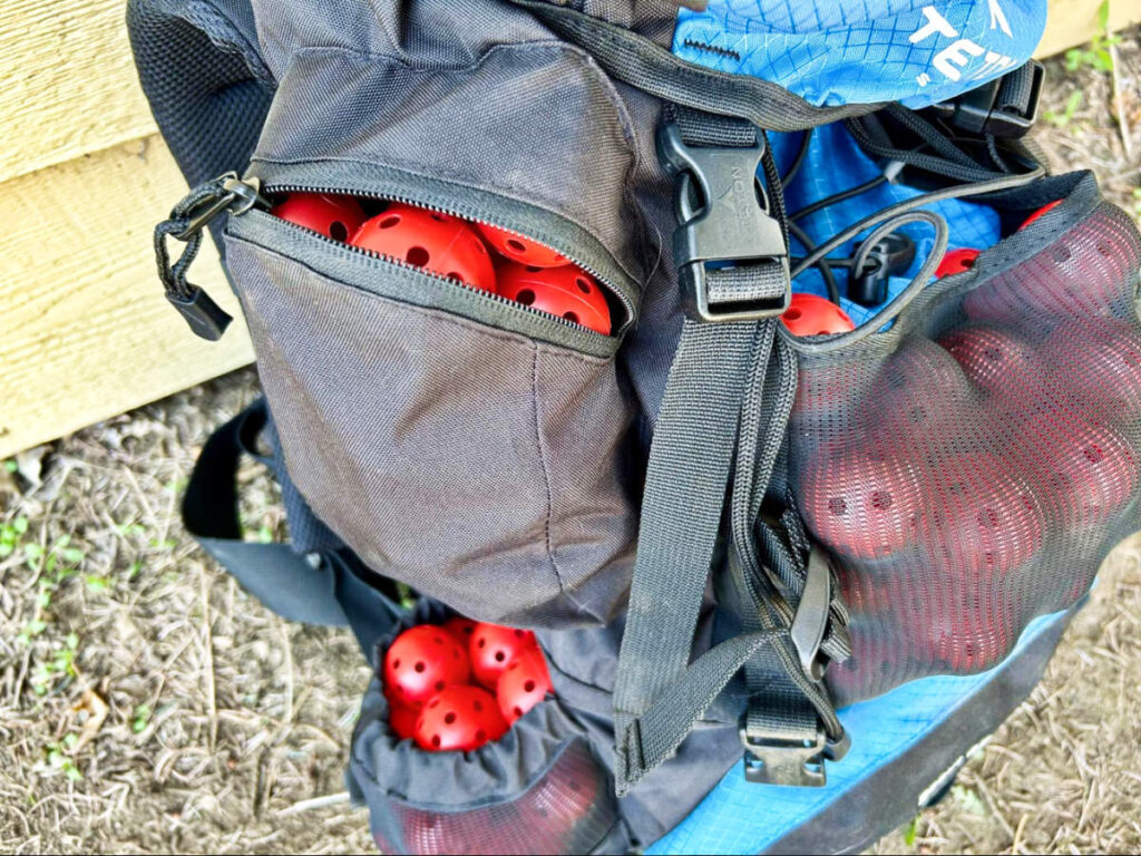 View of the Teton Sports Scout Backpack full of plastic golf balls