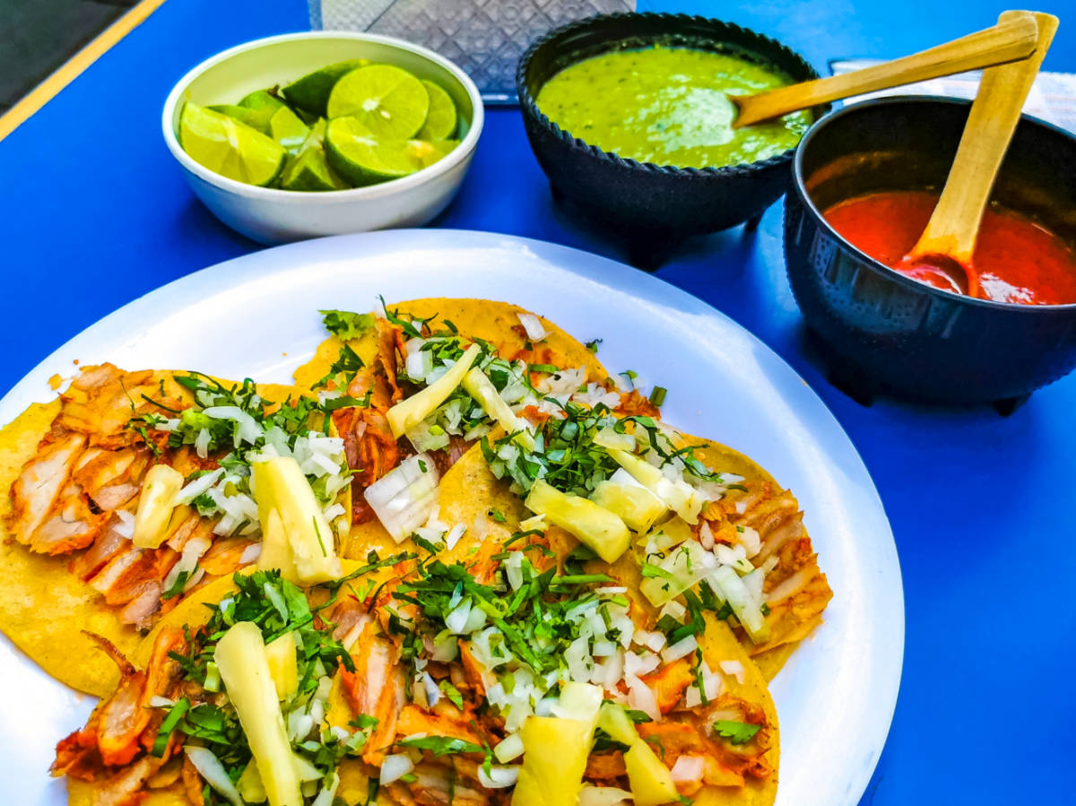 Mexican tacos with lime hot sauce pineapple and onions