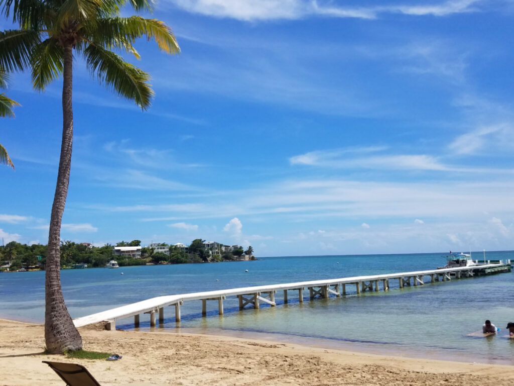 Long white boardwalk or pier on calm water in Playa Caña Gorda