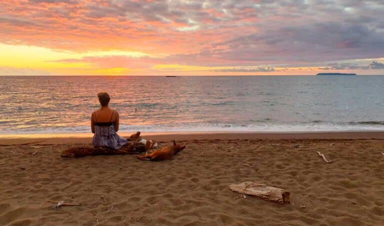 The author sitting on the sand, admiring the view in Playa Hermosa during sunset