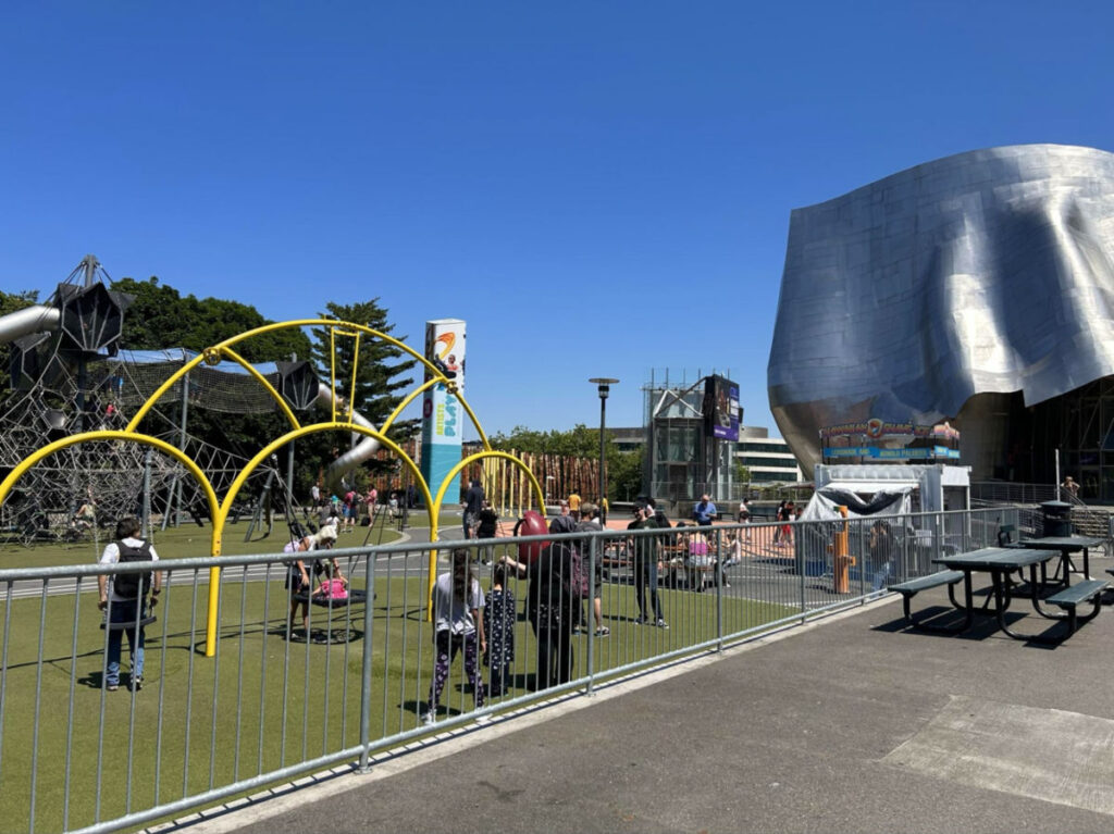 View of people wandering around the Seattle Center playground near the Museum of Pop Culture