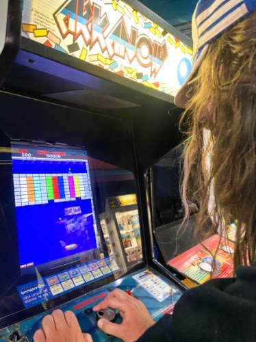 A man playing the old-school video game at the arcade in Santa Cruz Beach Boardwalk