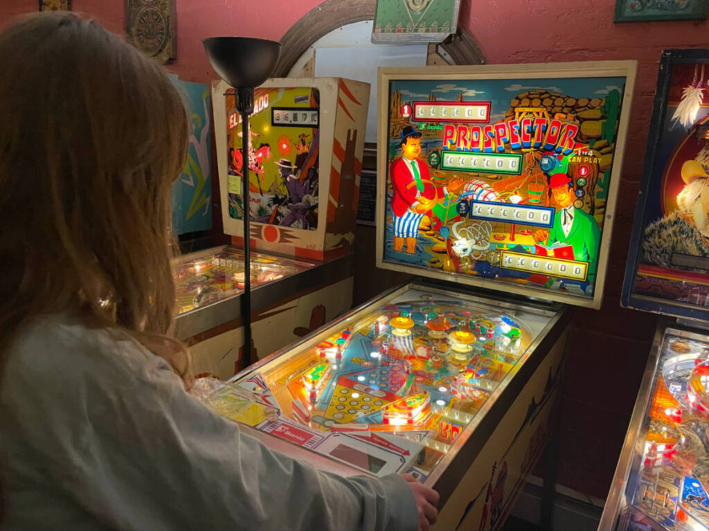 A kid playing pinball games