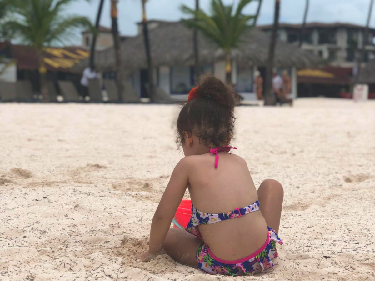 Author's daughter playing in the sand of Playa Bibijagua in Bavaro